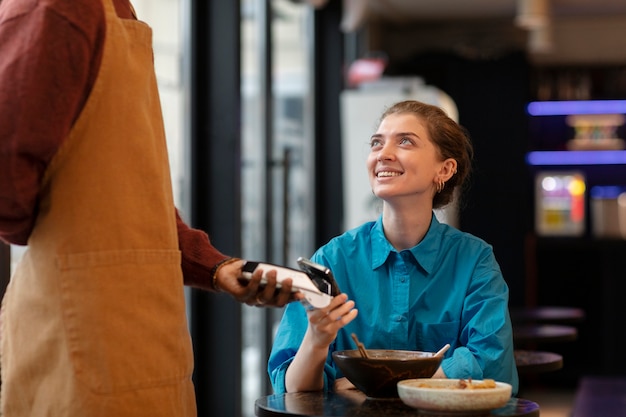 Photo person paying contactless for food at restaurant
