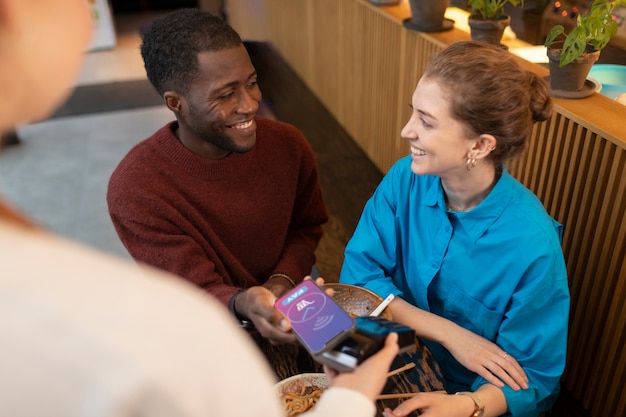 Photo person paying contactless for food at restaurant