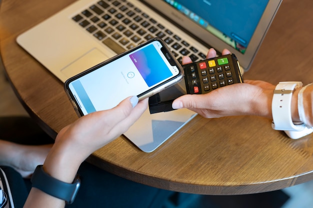 Photo person paying with its smartphone wallet app