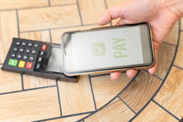 Photo person paying with its smartphone wallet app