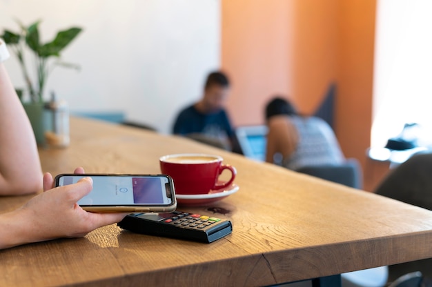 Photo person paying with its smartphone wallet app