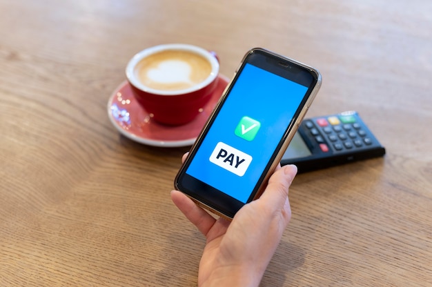 Person paying with its smartphone wallet app