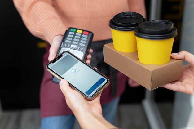 Person paying with its smartphone wallet app