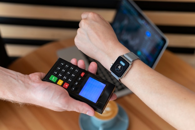 Photo person paying with its smartwatch wallet app