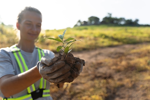 Photo person planting tree on the countryside