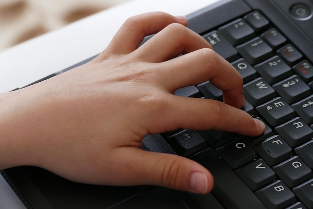 A person playing computer game with computer keyboard