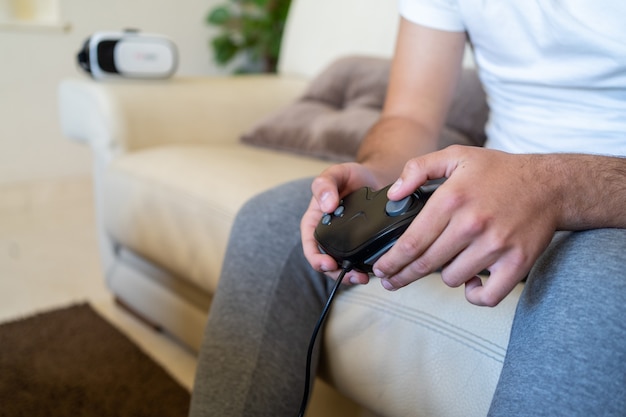 Person playing video games on a sofa