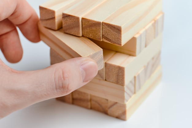 Person playing with wooden blocks