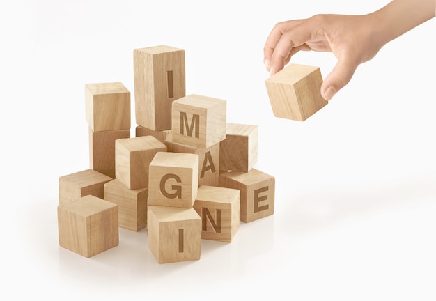 Person playing with wooden toy blocks