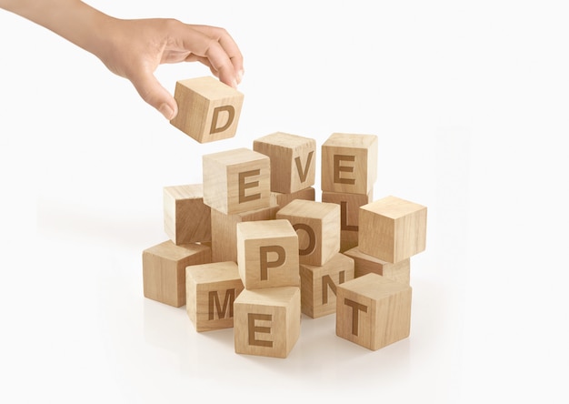 Person playing with wooden toy blocks