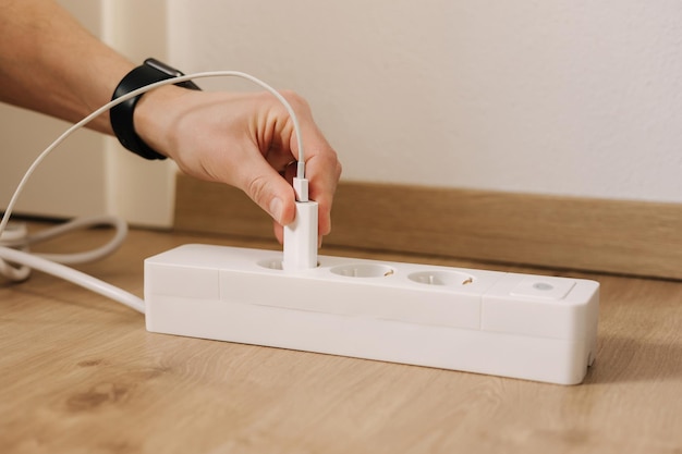 A person plugs into a power strip.