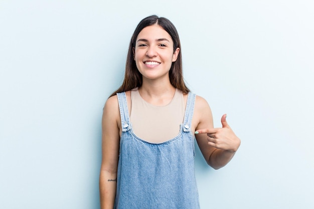 Person pointing by hand to a shirt copy space proud and confident