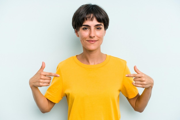 Person pointing by hand to a shirt copy space proud and confident