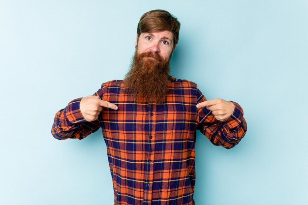 Person pointing by hand to a shirt copy space proud and
confident