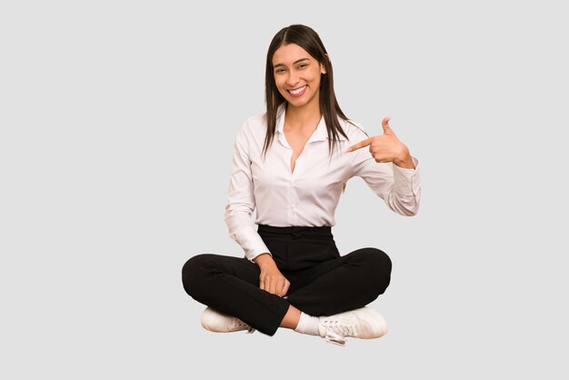 Person pointing by hand to a shirt copy space proud and confident