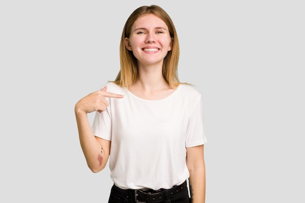 Person pointing by hand to a shirt copy space proud and confident