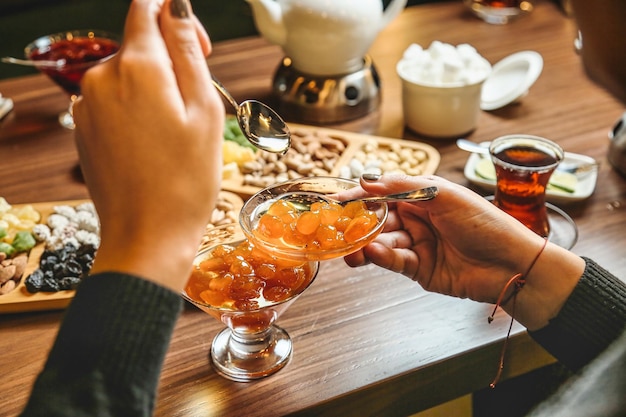 Foto persona che versa vino rosso in un bicchiere da vino a una cena di lusso