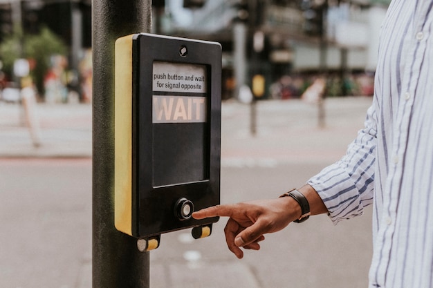 Person pressing a pedestrian cross push button