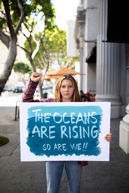 Person protesting with placard in the city for world environment day