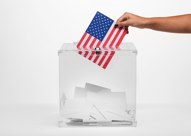 Photo person putting an american vote in ballot box