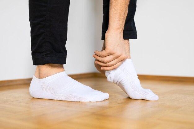 Person putting on white ankle socks