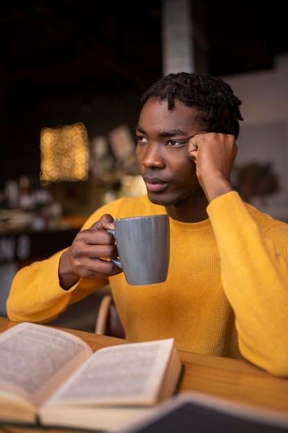 Person reading a book in a cafe