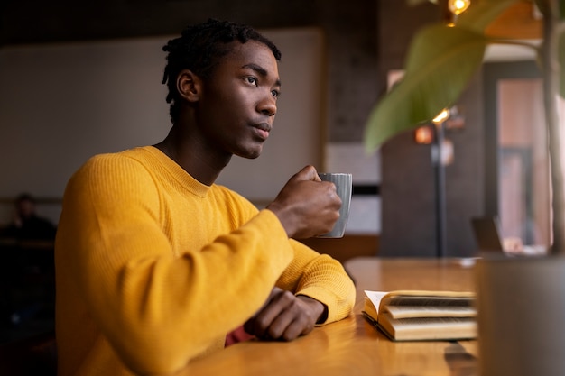 Person reading a book in a cafe