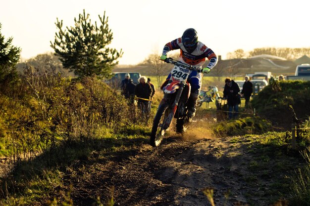 Photo person riding motorcycle on field