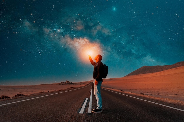 Person on the road under the milky way at night