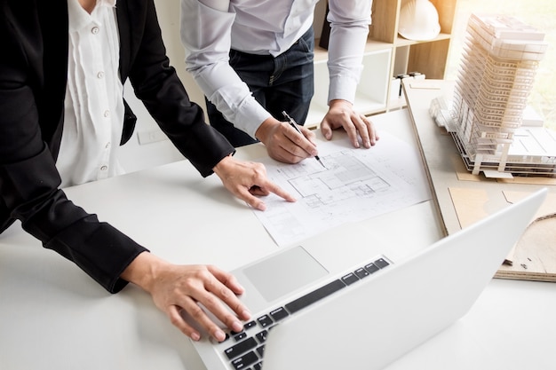 Person's engineer Hand Drawing Plan On Blue Print with architect equipment