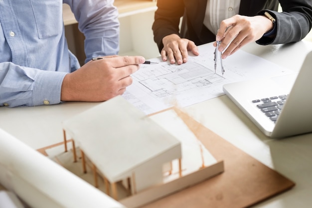 Person's engineer Hand Drawing Plan On Blue Print with architect equipment