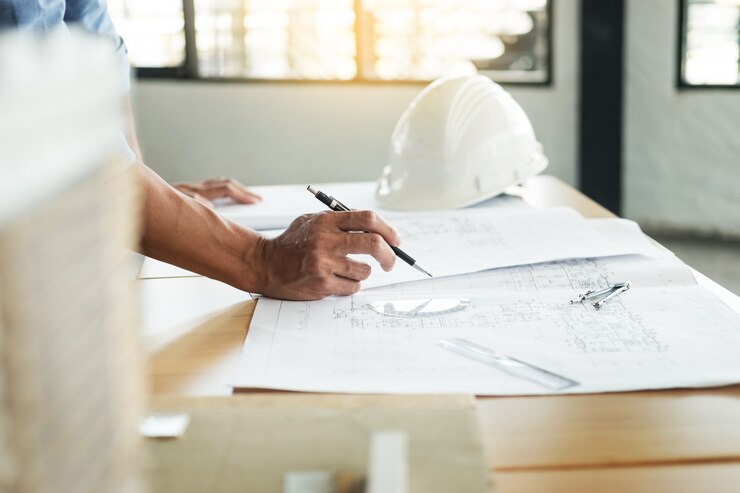 Photo person's engineer hand drawing plan on blue print 