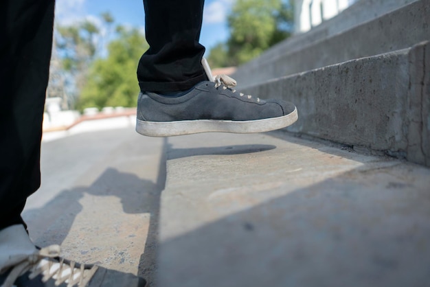 A person's foot making a step on the stairs