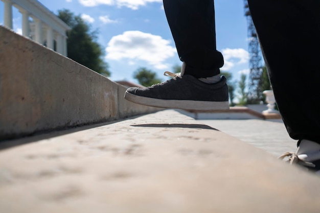 A person's foot making a step on the stairs