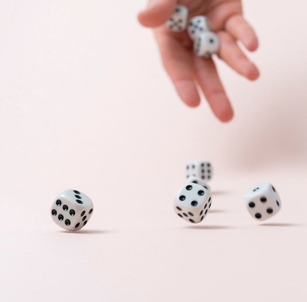 Photo person's hand roll the dice cubes on the table, win gamble casino