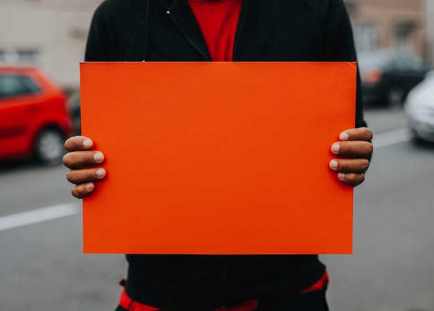 Person showing a blank board to support a movement