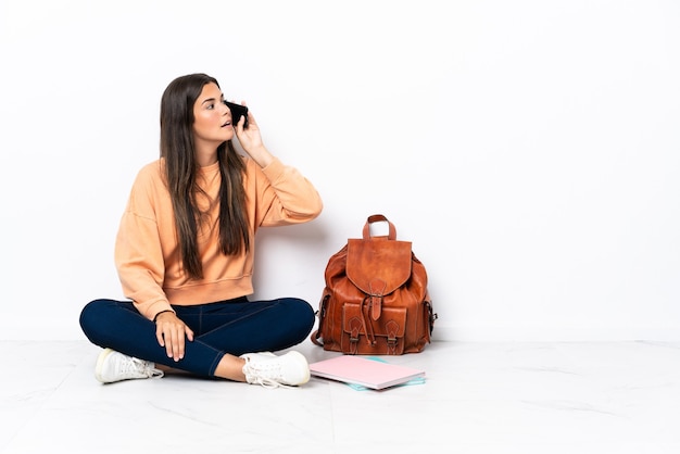 Person sitting on the floor over isolated background