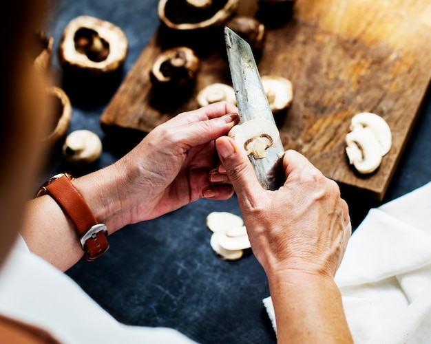 A person slicing portobello mushroom