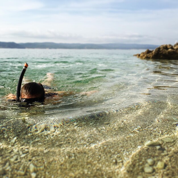 写真 海でシュノーケリングをする人