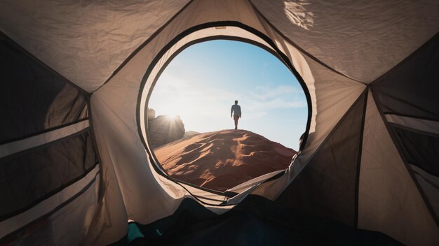 Photo a person standing in a tent with the words  camp  on the side