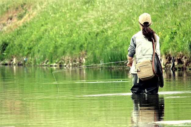 Person standing in water for fishing