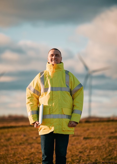 Person standing next to wind turbine