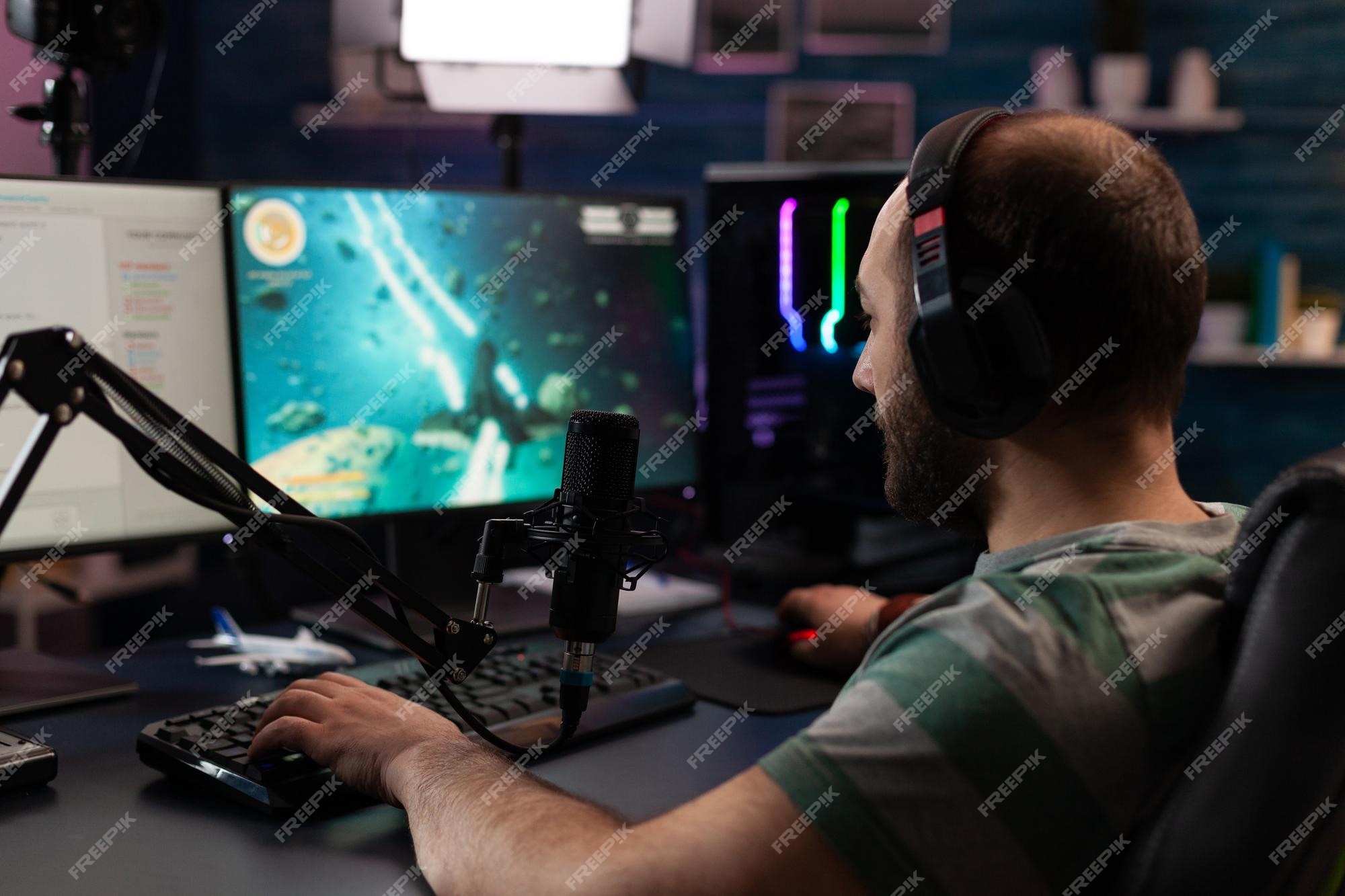 Premium Photo  Person streaming video games online with live chat. player  using headphones and microphone on computer, to play gameplay on live  stream. man broadcasting game with equipment at desk.