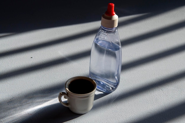 Person sweetening coffee with liquid sweetener