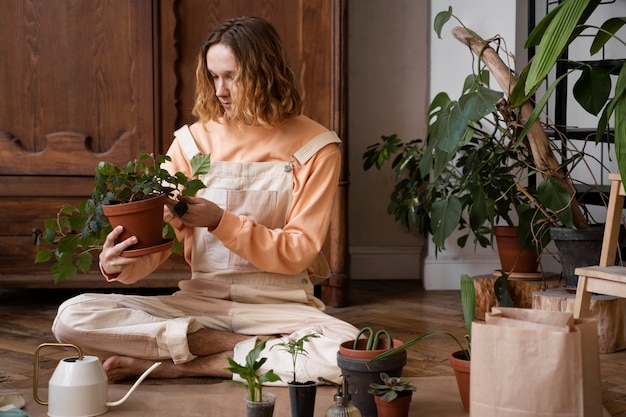 Person transplanting plants in new pots