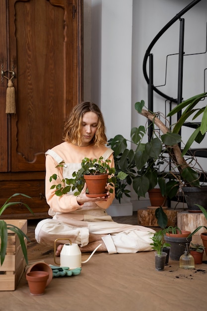 Person transplanting plants in new pots