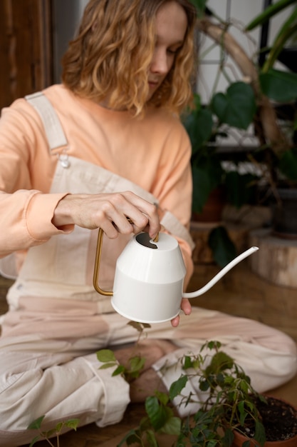 Photo person transplanting plants in new pots