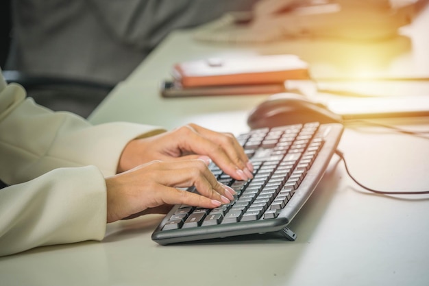 A person typing on a keyboard with the word computer on the right side.