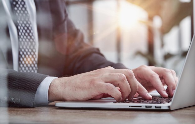 Person typing on laptop keyboard businessman working on laptop