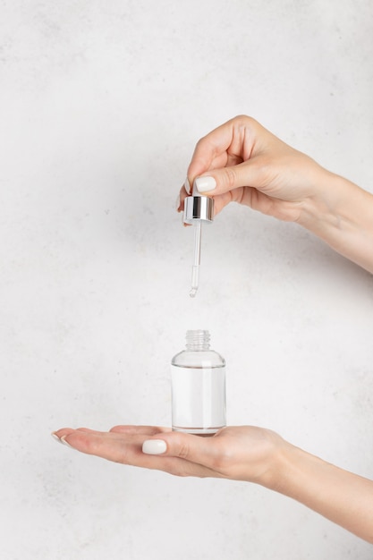 Person uses a moisturizing serum with a pipette